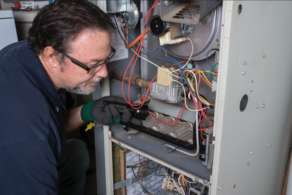 HVAC Technician Working on a Natural Gas Furnace