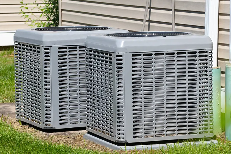 A picture of outdoor air conditioner units side by side 