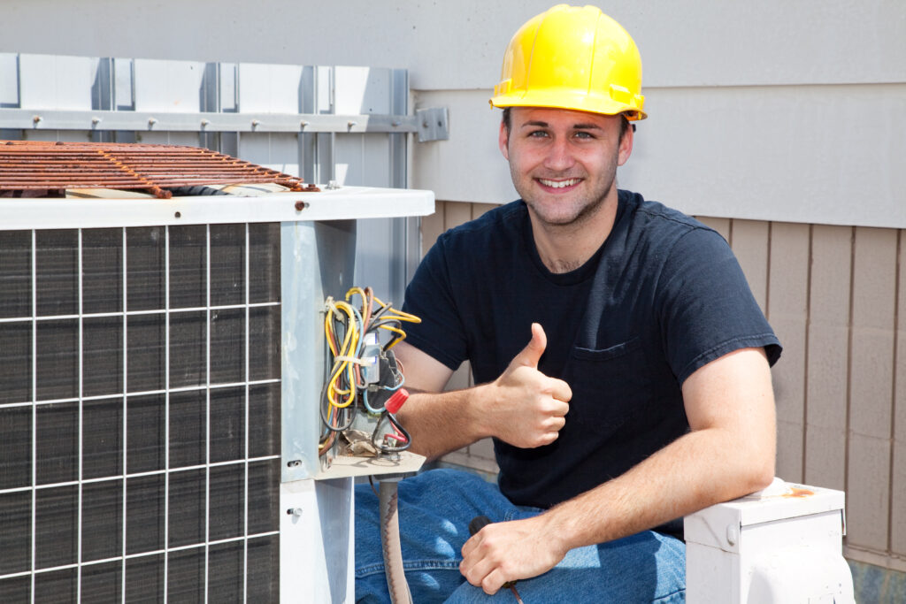 HVAC Technician Working on an Air Conditioner Giving a Thumbs Up