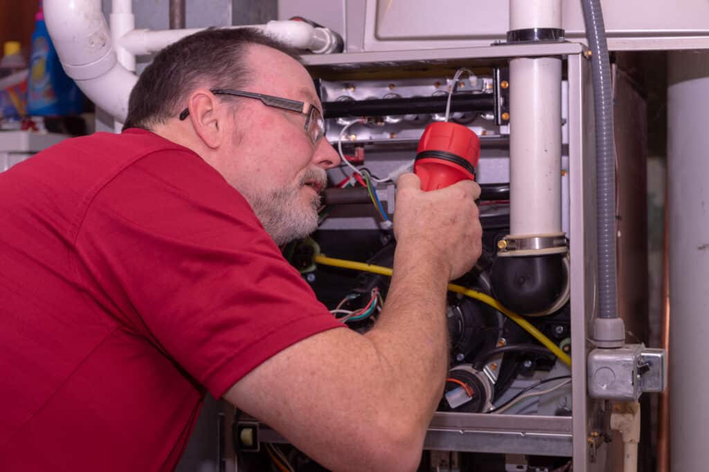 An HVAC Technician Checking For Common Furnace Problems