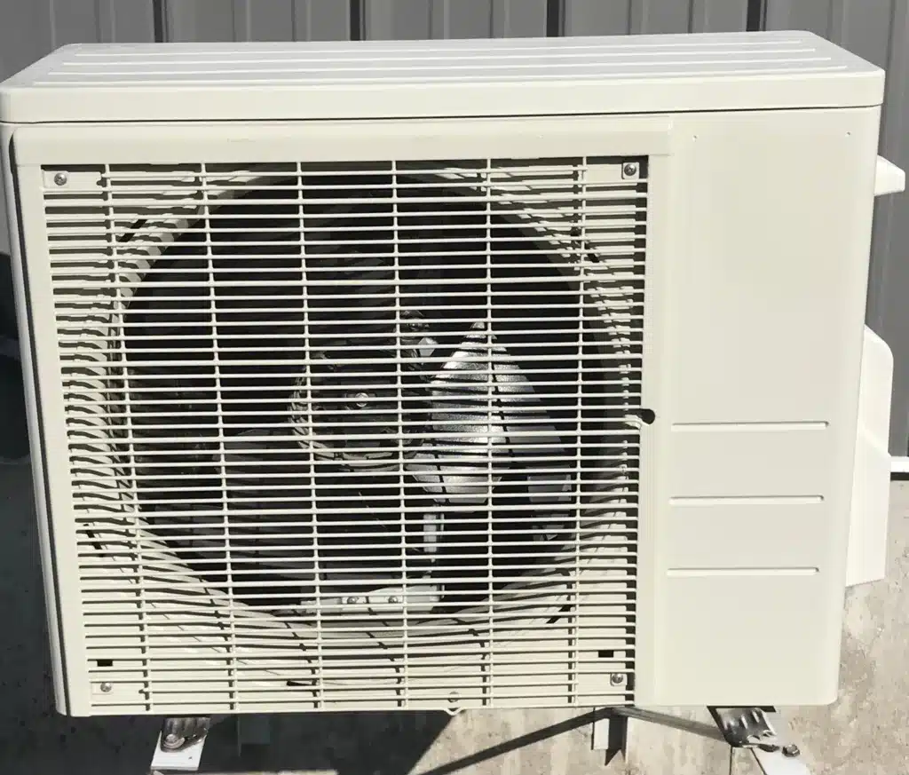 A beige outdoor ductless unit