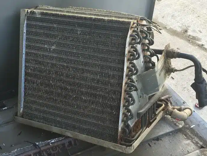 A dirty, rusted evaporator coil
