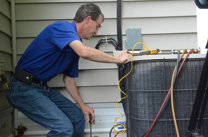 HVAC technician performing regular maintenance